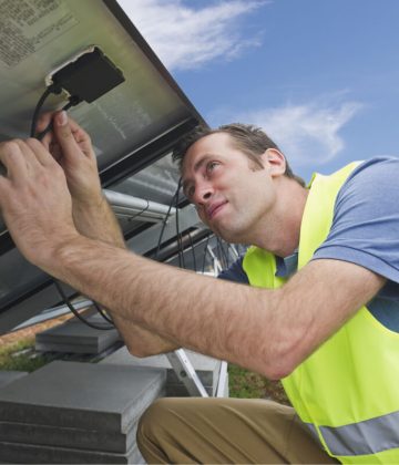 germany-munich-technician-fixing-cable-of-solar-2022-01-22-00-58-39-utc.jpg